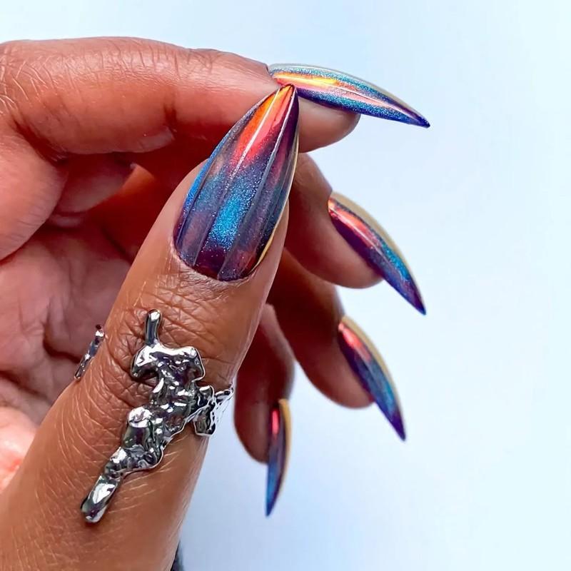 Hand with multichrome metallic nails and an artistic silver ring - مدل ناخن مخملی